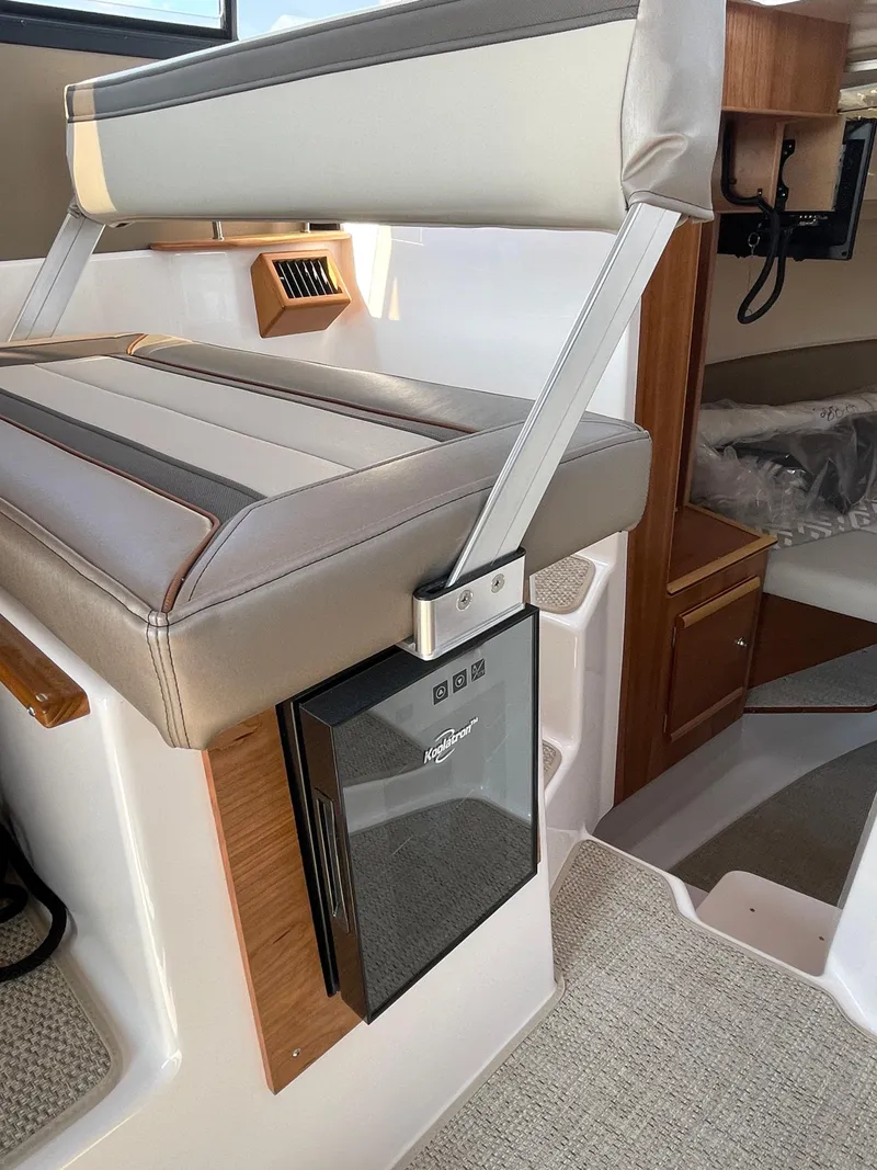 Slide: The Image of 2026 Cutwater C-288 Coupe interior with cushioned seating and compact fridge. - 37