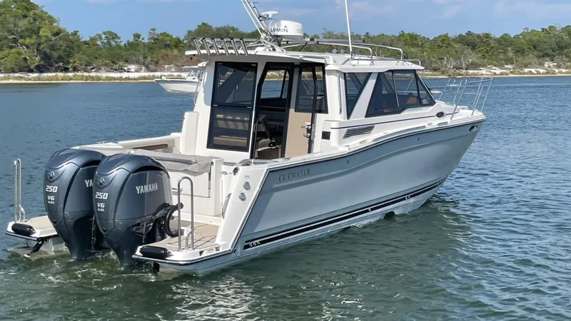 Slide: The Image of 2026 Cutwater C-288 Coupe boat with twin Yamaha engines on a calm lake. - 4