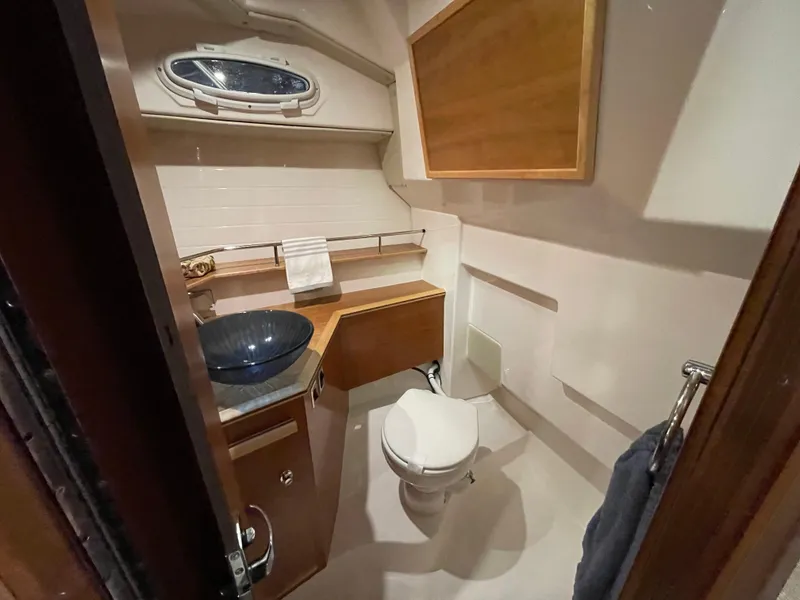 Slide: The Image of 2026 Cutwater C-288 Coupe bathroom with modern sink, toilet, and wooden cabinetry. - 41