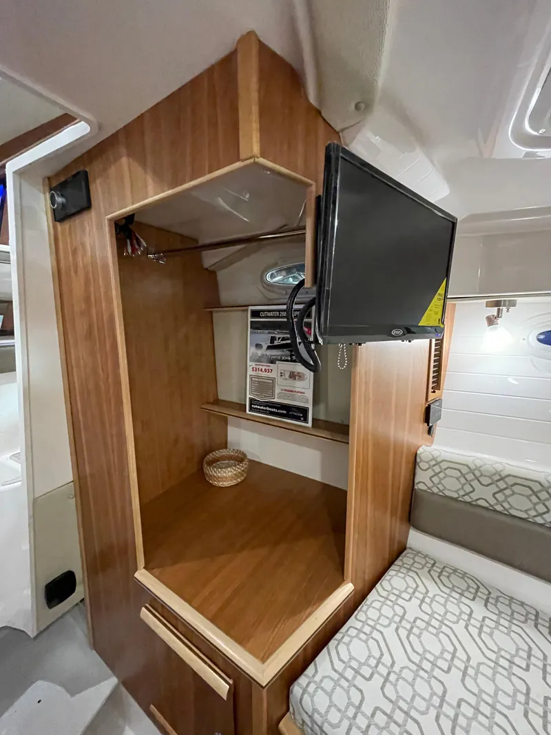 Slide: The Image of 2026 Cutwater C-288 Coupe interior with wooden cabinetry, TV, and seating area. - 43