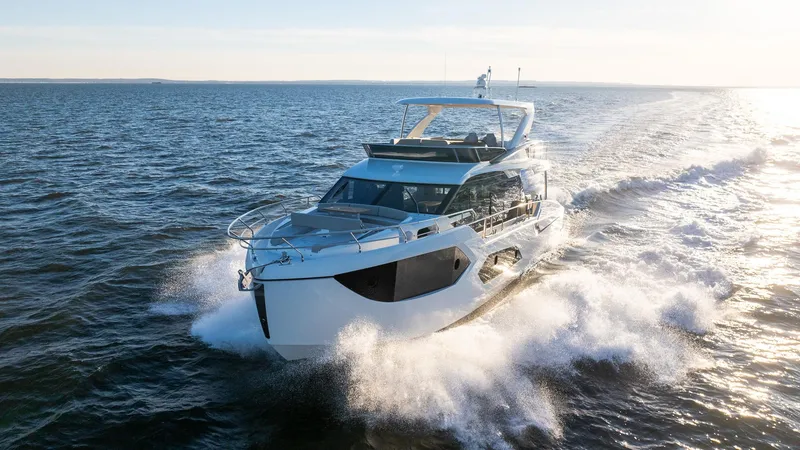 The Image of 2025 Absolute 60 Fly yacht cruising on open water at sunset. - 0