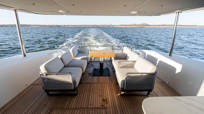 Slide: The Image of Luxurious 2025 Absolute 60 Fly yacht deck with elegant seating and ocean view. - 11