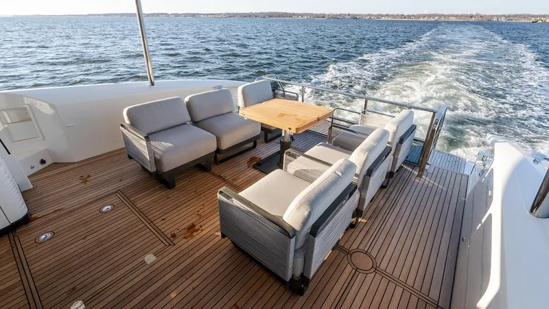 Slide: The Image of Luxury deck of 2025 Absolute 60 Fly yacht with seating and ocean view. - 14