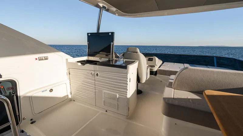 Slide: The Image of Luxurious 2025 Absolute 60 Fly yacht deck with ocean view and modern amenities. - 17