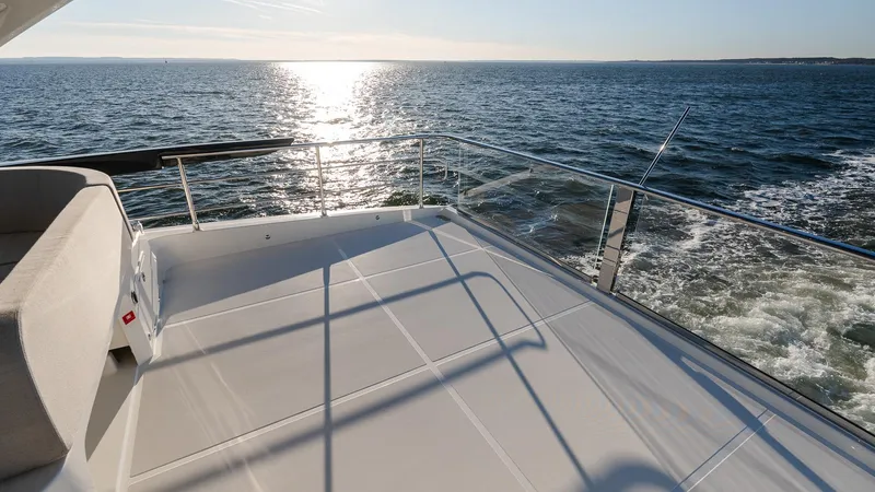Slide: The Image of Luxury yacht Absolute 60 Fly 2025 model cruising on open sea at sunset. - 23