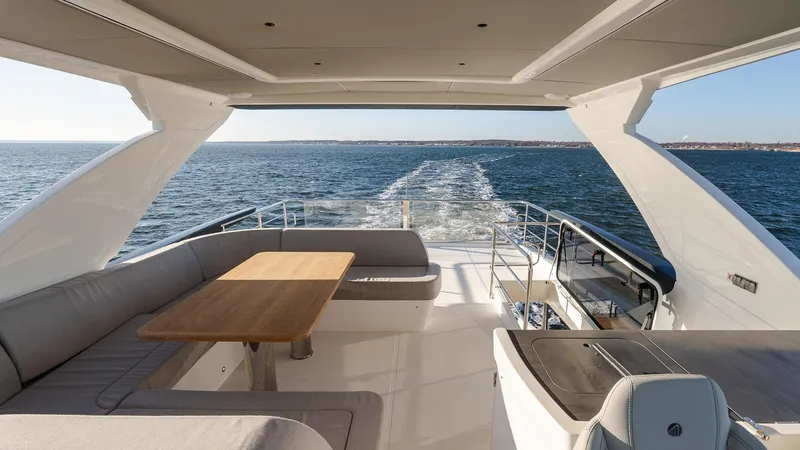 Slide: The Image of Luxurious 2025 Absolute 60 Fly yacht interior with ocean view and elegant seating area. - 25