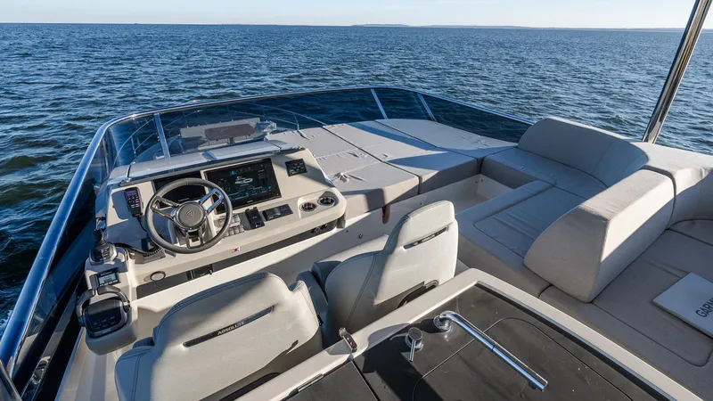 Slide: The Image of 2025 Absolute 60 Fly yacht helm and seating area on open water. - 29