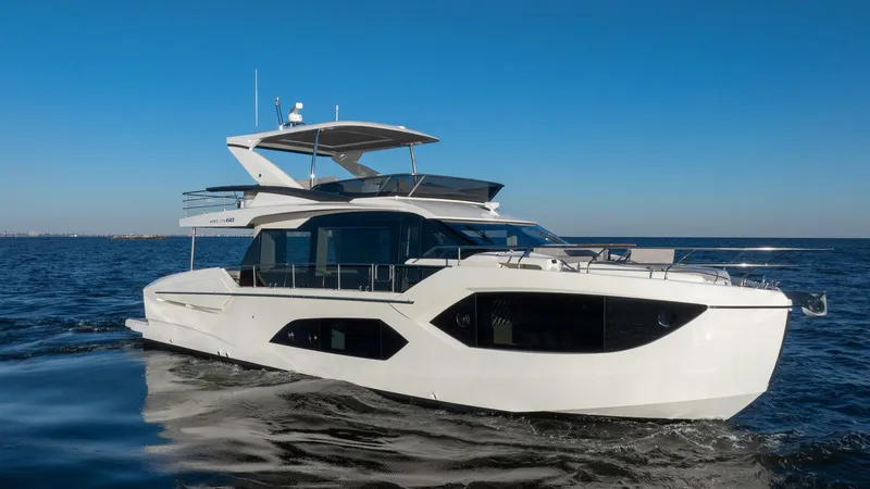 Slide: The Image of 2025 Absolute 60 Fly yacht cruising on open water under clear blue sky. - 3