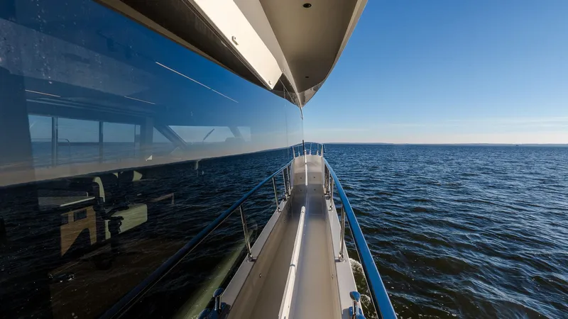 Slide: The Image of Luxurious Absolute 60 Fly yacht cruising on open sea, 2025 model, reflecting clear blue sky. - 32