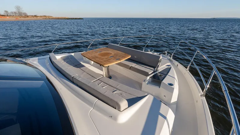 Slide: The Image of Luxury Absolute 60 Fly yacht deck with seating and table, 2025 model, on open water. - 33