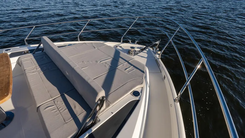 Slide: The Image of Luxurious 2025 Absolute 60 Fly yacht deck with sunbed, overlooking serene waters. - 34