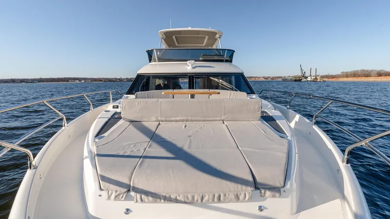 Slide: The Image of 2025 Absolute 60 Fly yacht on open water, featuring spacious sun deck and sleek design. - 35