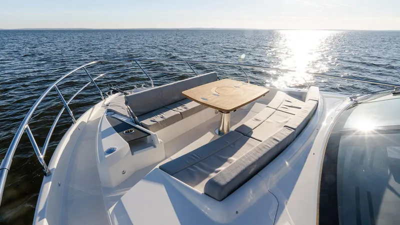 Slide: The Image of Luxurious 2025 Absolute 60 Fly yacht with sunlit deck and seating area on open water. - 37