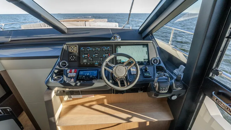 Slide: The Image of Cockpit of 2025 Absolute 60 Fly yacht with advanced navigation controls and ocean view. - 48