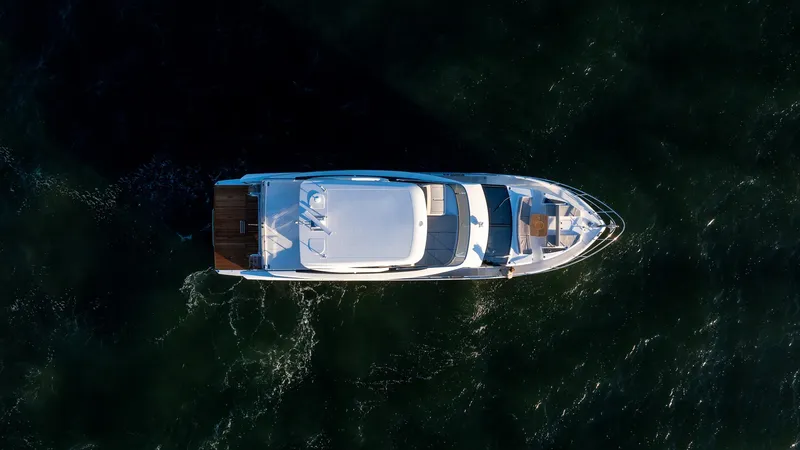 Slide: The Image of Aerial view of 2025 Absolute 60 Fly yacht cruising on dark water. - 8