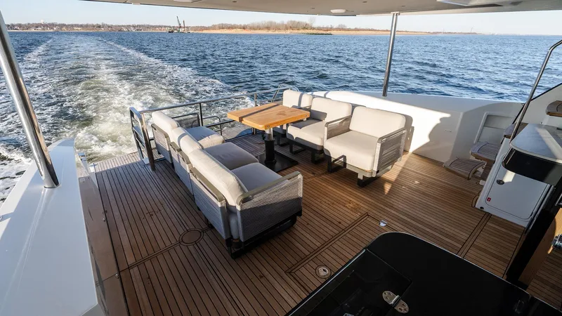 Slide: The Image of Luxury deck of 2025 Absolute 60 Fly yacht with elegant seating and ocean view. - 9