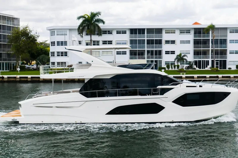 The Image of 2026 Absolute 60 Fly yacht cruising near modern waterfront buildings. - 0