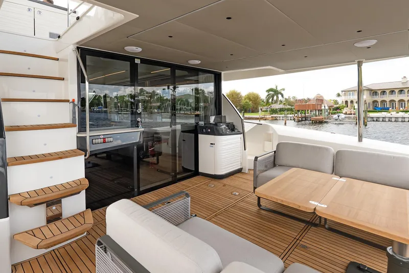 Slide: The Image of Luxurious 2026 Absolute 60 Fly yacht deck with seating, table, and staircase. - 10