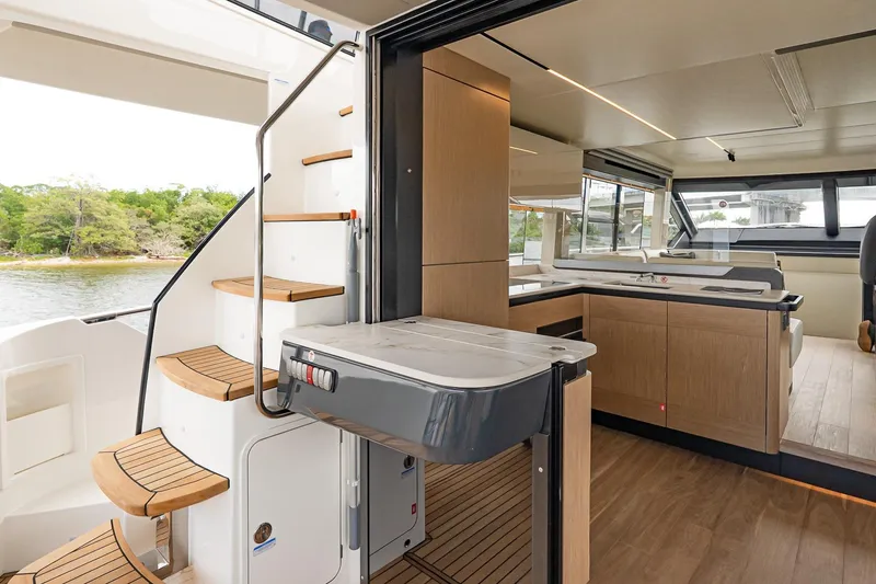 Slide: The Image of Luxurious interior of 2026 Absolute 60 Fly yacht with modern kitchen and elegant staircase. - 12