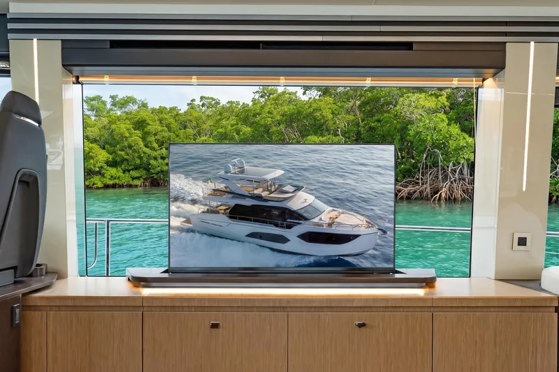 Slide: The Image of Interior view of Absolute 60 Fly yacht, showcasing modern design and scenic water backdrop. - 26