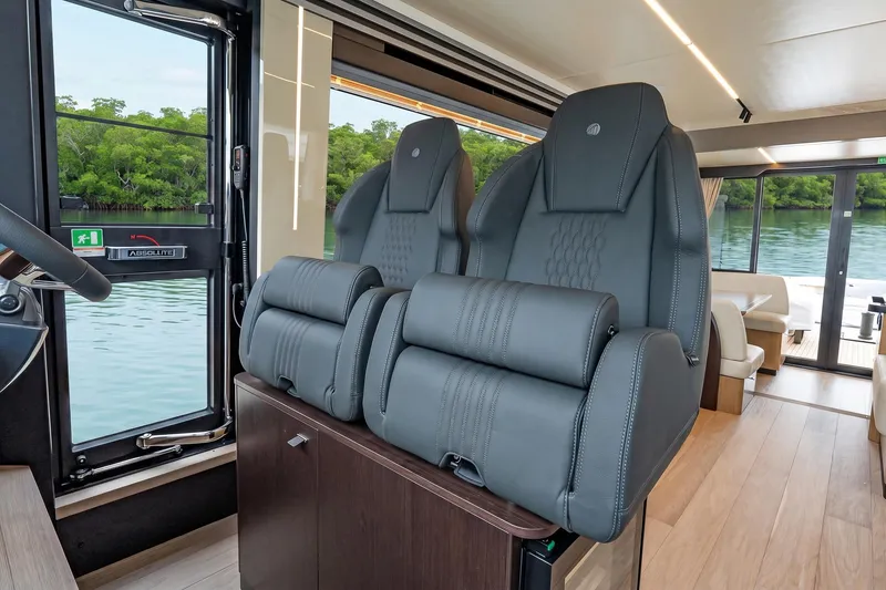 Slide: The Image of Luxurious interior of 2026 Absolute 60 Fly yacht with plush seating and scenic water view. - 28