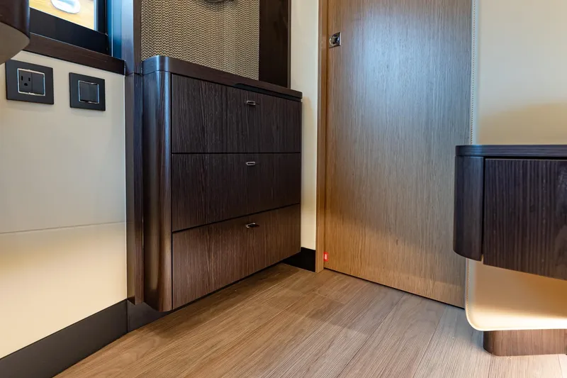 Slide: The Image of Interior of 2026 Absolute 60 Fly yacht featuring sleek wood cabinetry and modern design. - 44
