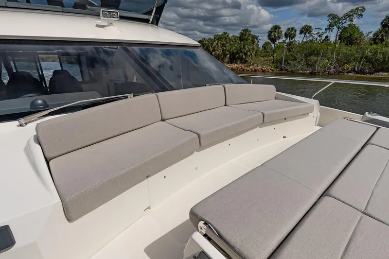 Slide: The Image of Luxurious seating on the 2026 Absolute 60 Fly yacht, with scenic waterway backdrop. - 55