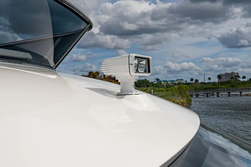 Slide: The Image of 2026 Absolute 60 Fly yacht spotlight on deck, with scenic waterfront background. - 58
