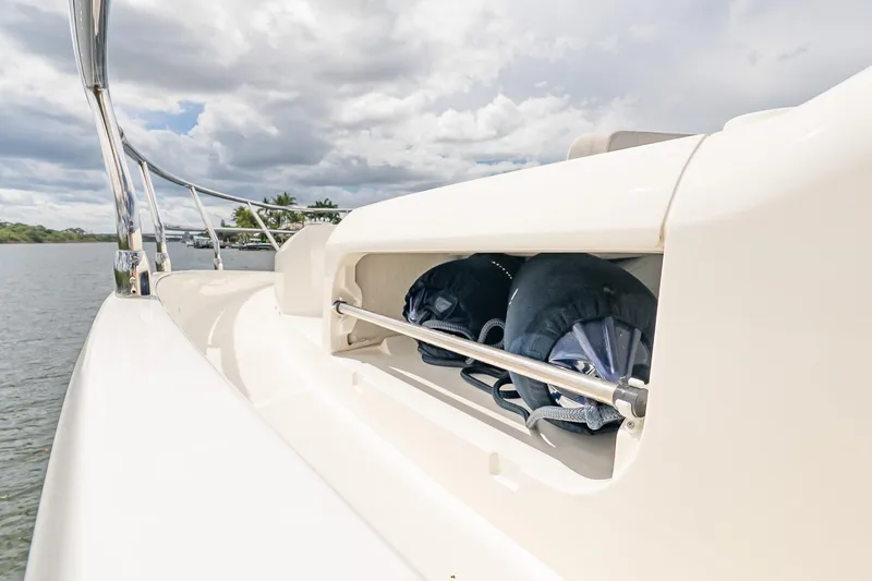 Slide: The Image of 2026 Absolute 60 Fly yacht with storage compartment, docked on a calm waterway. - 59