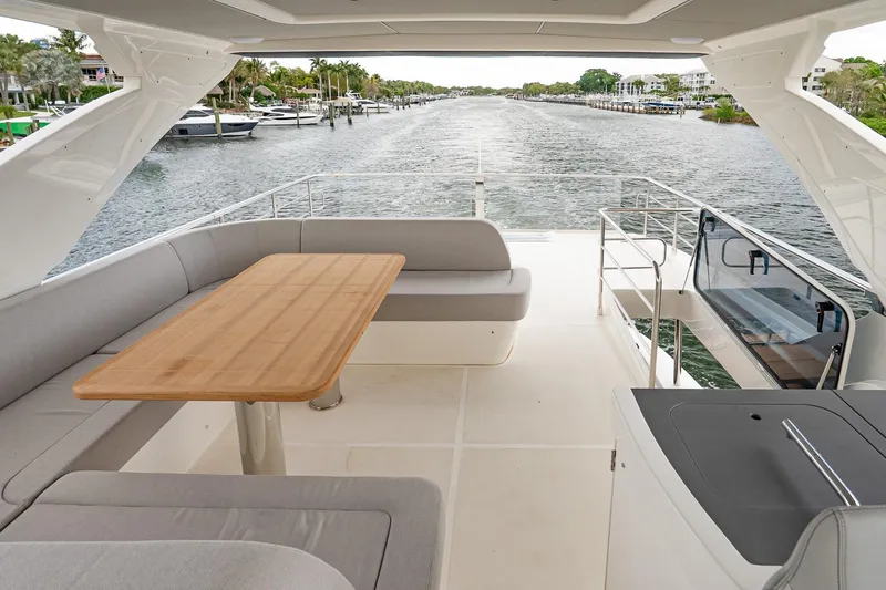 Slide: The Image of Luxurious 2026 Absolute 60 Fly yacht deck with elegant seating and scenic waterway view. - 60