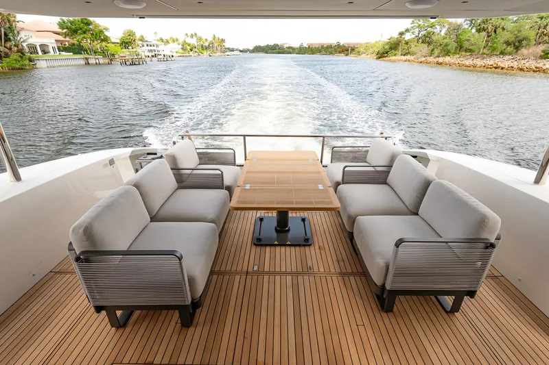Slide: The Image of Luxurious 2026 Absolute 60 Fly yacht deck with elegant seating and scenic waterway view. - 7