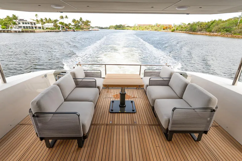 Slide: The Image of Luxurious 2026 Absolute 60 Fly yacht deck with elegant seating and scenic water view. - 8