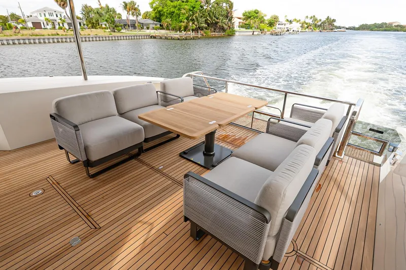 Slide: The Image of Luxurious 2026 Absolute 60 Fly yacht deck with elegant seating and scenic water view. - 9