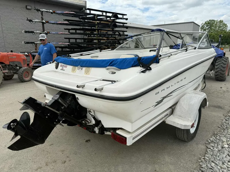 Slide: The Image of 2005 Bayliner 175 Bowrider boat on trailer, parked outdoors near equipment. - 6