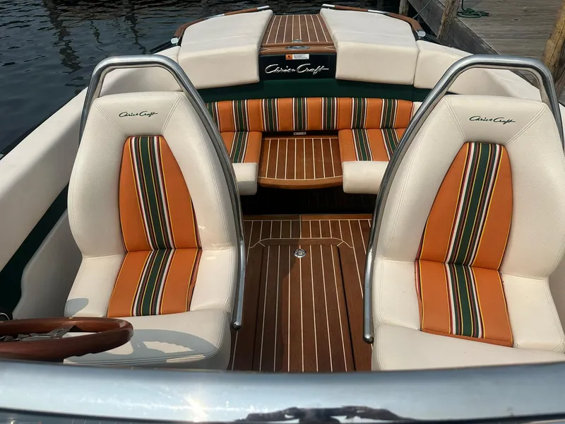 Slide: The Image of 2018 Chris-Craft Capri 21 boat interior with striped orange and white seats. - 14