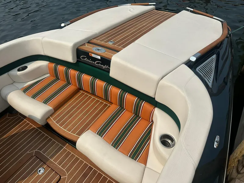 Slide: The Image of 2018 Chris-Craft Capri 21 boat interior with striped upholstery and wood accents. - 3
