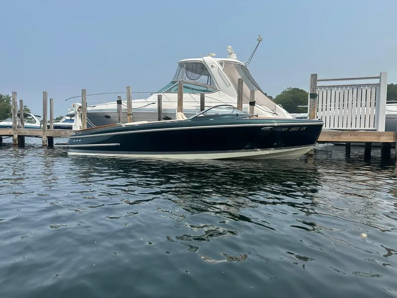 Slide: The Image of 2018 Chris-Craft Capri 21 boat docked on calm water. - 4
