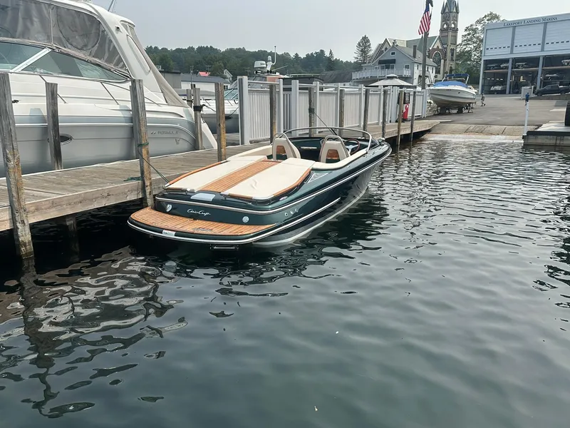 Slide: The Image of 2018 Chris-Craft Capri 21 boat docked at a marina, showcasing elegant design and craftsmanship. - 7