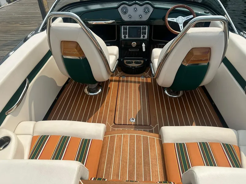 Slide: The Image of 2018 Chris-Craft Capri 21 interior with striped seats and wooden flooring. - 9