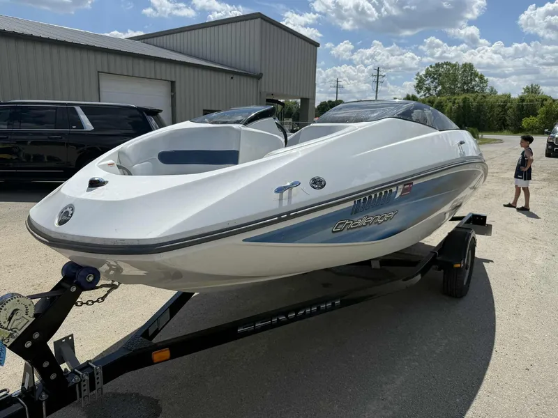 The Image of 2006 Sea-Doo 180 Challenger boat on trailer, parked outdoors under a cloudy sky. - 0