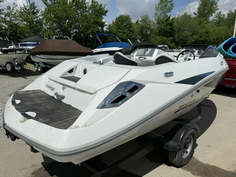 Slide: The Image of 2006 Sea-Doo 180 Challenger boat on trailer, parked outdoors. - 13