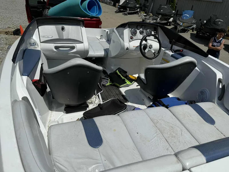 Slide: The Image of 2006 Sea-Doo 180 Challenger interior with seating and dashboard, parked outdoors. - 4