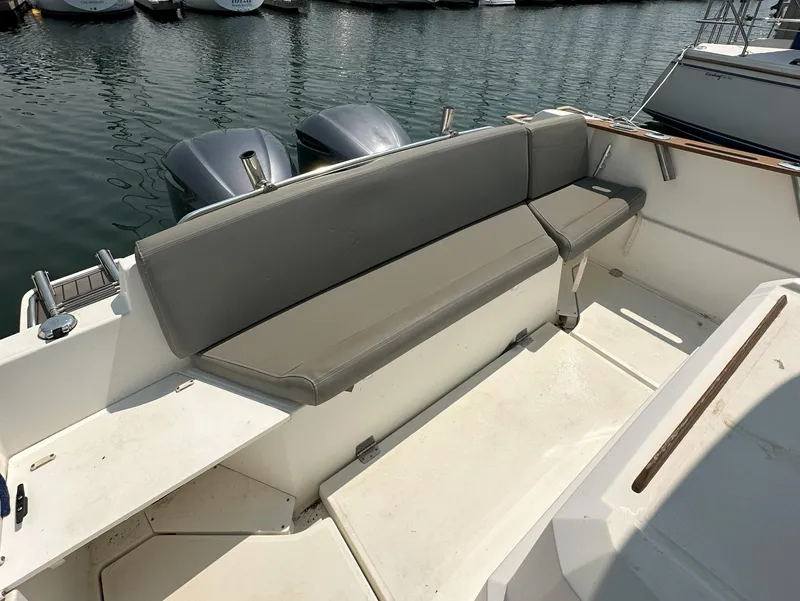 Slide: The Image of Beneteau Barracuda 9 Fly 2012 boat with cushioned seating and twin outboard motors. - 12