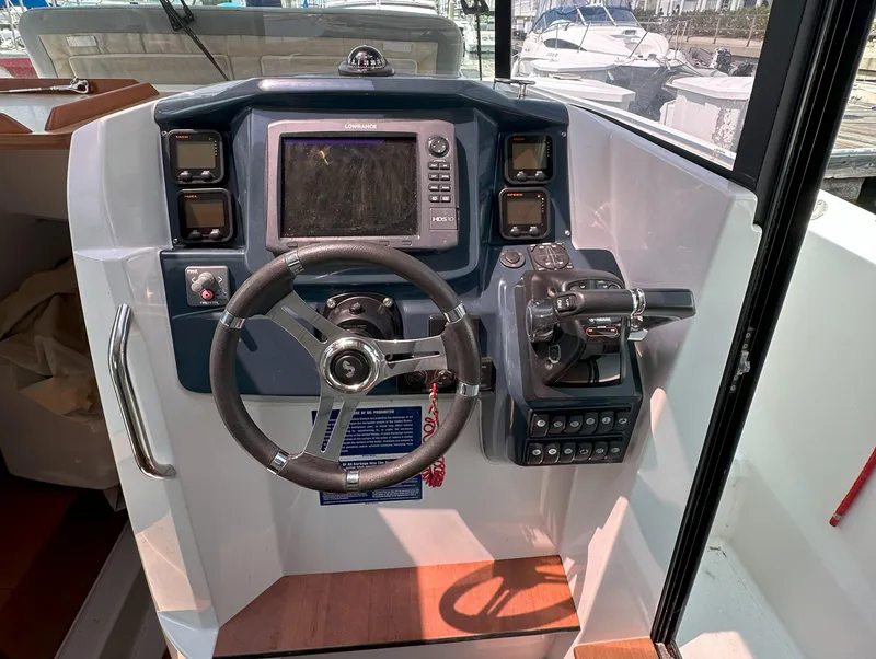 Slide: The Image of Control panel of 2012 Beneteau Barracuda 9 Fly with steering wheel and navigation equipment. - 14