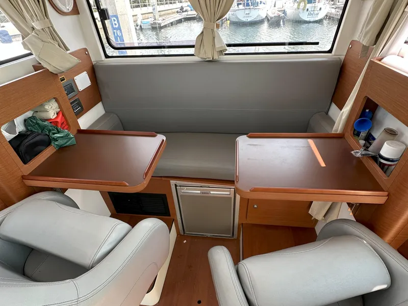 Slide: The Image of Interior of 2012 Beneteau Barracuda 9 Fly with seating, tables, and storage compartments. - 15