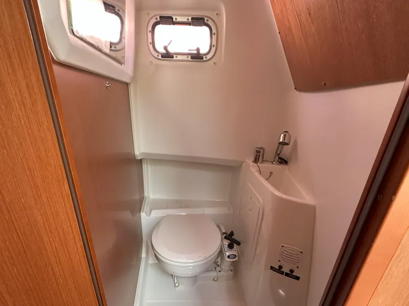 Slide: The Image of Compact bathroom in 2012 Beneteau Barracuda 9 Fly boat, featuring toilet and sink. - 18