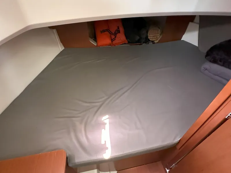 Slide: The Image of Interior cabin of 2012 Beneteau Barracuda 9 Fly with a neatly made bed. - 19