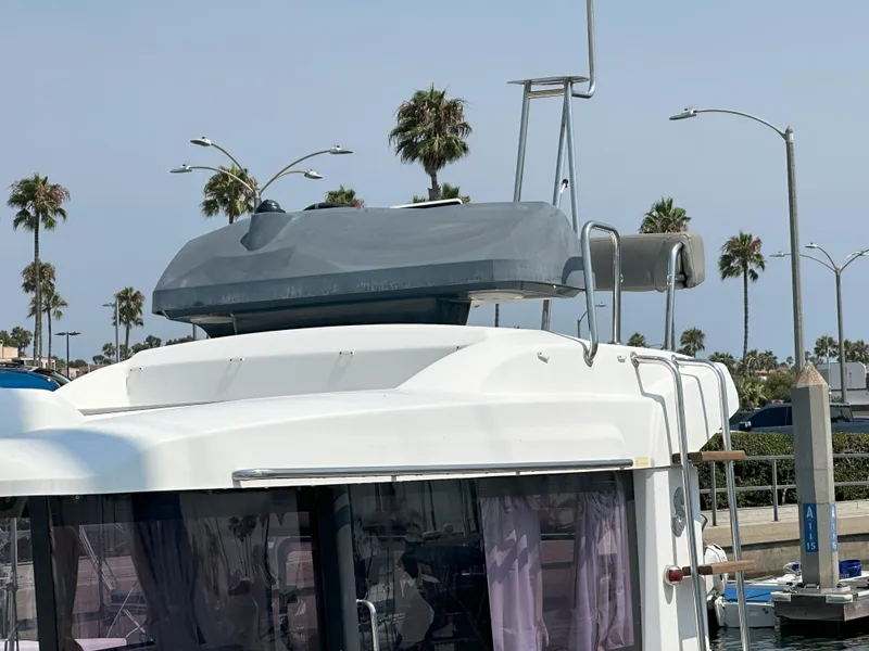 Slide: The Image of 2012 Beneteau Barracuda 9 Fly boat docked, featuring flybridge and palm trees in the background. - 20