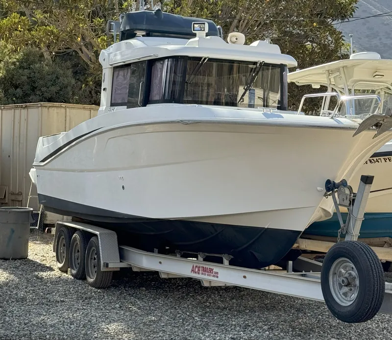 Slide: The Image of 2012 Beneteau Barracuda 9 Fly on trailer, parked outdoors. - 22