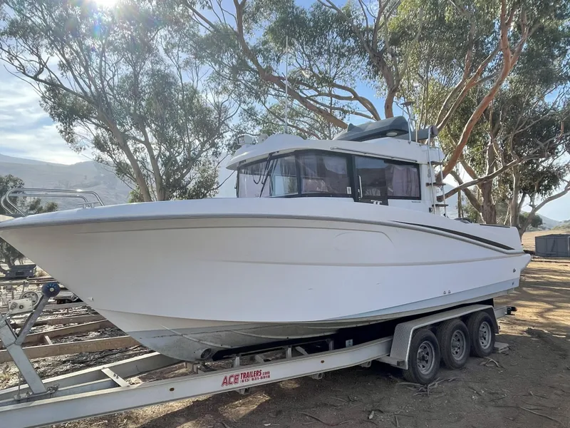 Slide: The Image of 2012 Beneteau Barracuda 9 Fly boat on trailer, surrounded by trees. - 3